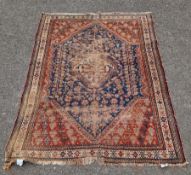 Persian rug with blue centre piece with green and red, multiple borders with cream, red, orange,
