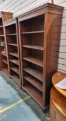 Pair of modern mahogany bookcases in the Regency manner with moulded dentil pediments, five