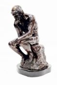 After Auguste Rodin, cast bronze figure of ' The Thinker ' raised on a shaped black slate base, 38cm