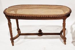 French walnut oval window seat in the Louis XVI-style with cane panel seat, carved frieze and raised