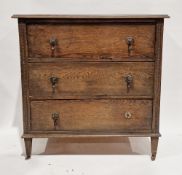 Early 20th century oak chest of three long drawers with moulded beaded details to sides and raised