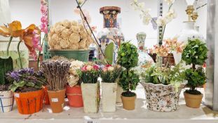 A quantity of faux floral arrangements the majority contained within ceramic planters to include
