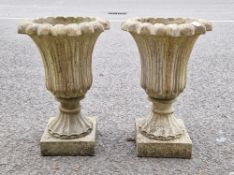 Pair of composite stone tulip form garden urn-shaped jardinieres on stand and a small composite