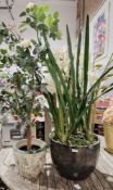 Pair of faux floral arrangements, one contained within a large grey pearlescent pot containing an
