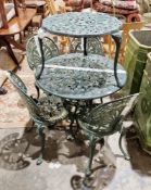 Distressed dark green painted metal garden table with four chairs and an additional smaller table