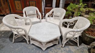 Four cane conservatory armchairs in white painted wicker and a matching glass-topped conservatory