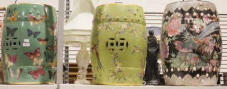 Three ceramic Chinese style garden barrel seats, one decorated with butterflies another with birds