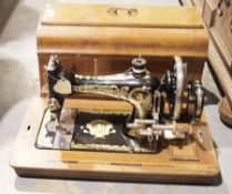 Three early 20th century cased sewing machines, comprising: a Singer, model no. E866762, a Jones,
