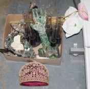 A sculpture of a hand and forehand made out of circuitry, a pair of stands each containing six large