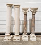 Two pairs of columns, one pair of simple design with floral bases and the other with marble