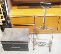 A chrome-effect fireplace surround along with a boot cleaner and a metal strong box