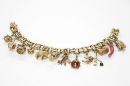 14ct gold charm bracelet, the double loop bracelet with multiple charms including boot inset with