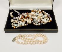 A single-strand pink and white coloured faux pearl necklace and a necklace of various coloured