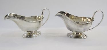 A pair of silver sauceboats by Roberts & Belk Sheffield 1942, of plain form with gadroon border on