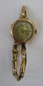 Lady's 9ct gold bracelet watch, the circular dial with engine turned decoration, the movement