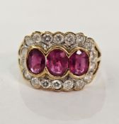 18ct gold, ruby and diamond ring, the three central rubies surrounded by diamonds, in rubover