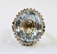 18ct gold, aquamarine and diamond dress ring, the central oval aquamarine surrounded by diamonds and