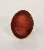 19th century gold-coloured metal and cornelian seal ring, the elliptical top intaglio engraved