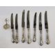 Seven sterling handled knives, floral and scroll decorated, and continental silver small caddy spoon - Image 1 of 3