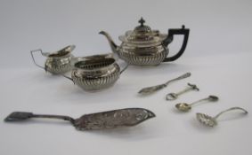 Silver plated three-piece tea set of half-luted oval form, a silver plated pierced fish slice, and a