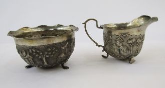 Foreign silver sugar basin and matching cream jug with scalloped inverted rim repousse decoration
