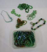 A quantity of green stone necklaces and others to include glass