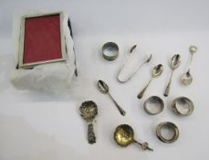 Collection of silver items including four napkin rings, sugar tongs, Queen Elizabeth II silver