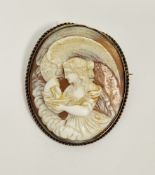 Victorian carved cameo and yellow metal mounted brooch, depicting Hebe and Zeus in the form of an