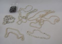 A long string of modern variegated grey/purple cultured pearls, four mother of pearl and cultured