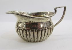 Late Victorian silver small cream jug, rounded oblong and semi-gadrooned, Birmingham 1891, maker's