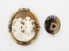 Victorian gilt metal shell cameo brooch, the shell carved with a figure of Cupid, and two other