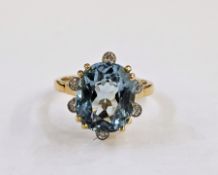 18ct gold, aquamarine and diamond ring, the oval aquamarine surrounded by six collet set diamonds,