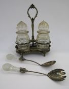 Silver plated cruet stand with lion mask decoration and fitted with two cut glass jars and covers,
