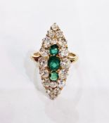 Gold-coloured metal, emerald and diamond dress ring, marquise-shaped with three rounded