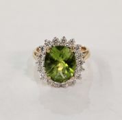 Modern 18ct gold, green zircon and diamond cluster ring, the oval zircon surrounded by diamonds,