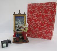 Music Box World resin Christmas model of Santa and two children beside light-up painting on easel (