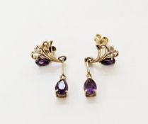 Pair of 9ct gold stud earrings, each set with a teardrop amethyst and diamond within the scrolling