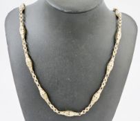 Victorian gold coloured watch chain with alternating belcher and pierced fancy links, 73cm long,