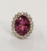 18ct gold, pink tourmaline and diamond dress ring set large oval tourmaline, surrounded by claw