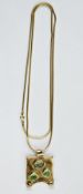 Modern 9ct gold stone set pendant, the curled rectangular pendant set with three pale blue and