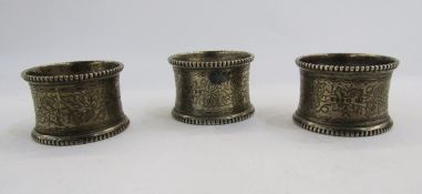 Set of three Victorian silver napkin rings, London 1875, William Evans, with gadrooned edge, foliate
