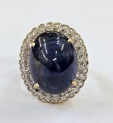 18ct gold dress ring, sapphire and diamond set large central oval cabochon sapphire surrounded by