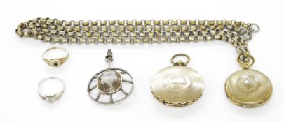 White metal pendant of circular design set with a central smoky quartz, a 9ct gold three-stone