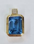 18ct gold, blue topaz and diamond pendant, the rectangular cut topaz with small diamond set loop
