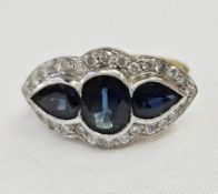 18ct gold, sapphire and diamond dress ring, the central oval sapphire 8mm x 5mm approx. flanked by