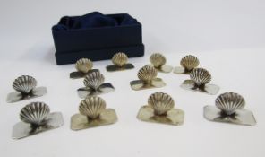 Set of 12 modern silver menu holders modelled as scallop shells, on rectangular bases with chamfered