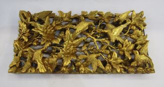 Chinese carved giltwood panel, circa 1920, carved in deep relief with birds and blossom, 54cm x 25cm
