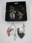 A pearl and pale blue stone silver coloured metal and a citrine purple and blue stone necklace,