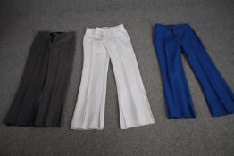 Three pairs of bespoke made vintage flared trousers in various colours.