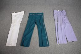 Three pairs of bespoke made vintage flared trousers in various colours.